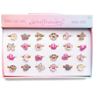 A collection of spinner fidget rings displayed in a box, featuring various designs such as hearts and flowers in multicolor and pink tones.