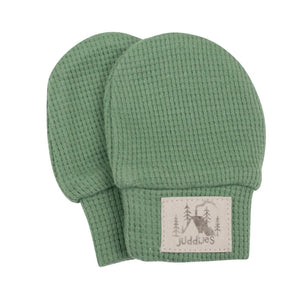 Pair of green baby mittens with a visible brand label on a white background
