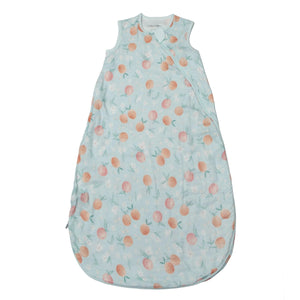 A lightweight muslin sleep sack with a floral pattern, predominantly in shades of peach and white on a light background.