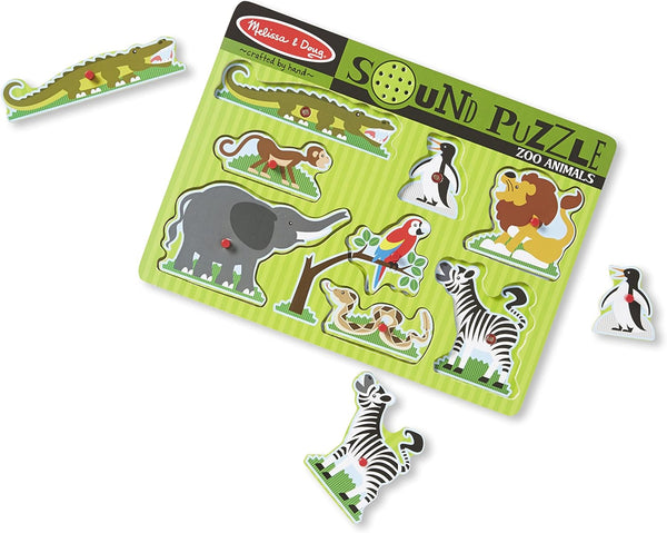 A colorful wooden sound puzzle featuring various zoo animals, with pegged pieces that include an elephant, giraffe, monkey, lion, parrot, zebra, and crocodile.