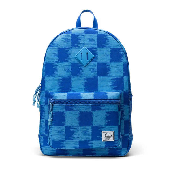A Herschel Heritage Youth backpack in blue with green and red accents, featuring multiple pockets and a branded shoulder tab.