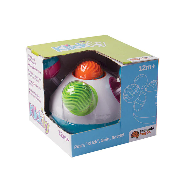 A colorful toy ball with a green, orange, and purple sections, packaged in a box labeled for ages 12 months and up. The toy is designed for pushing, spinning, and clicking activities.
