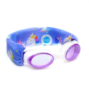 A pair of children's swim goggles with a unicorn and fairy pattern on a blue background, featuring shatter-resistant polycarbonate lenses.