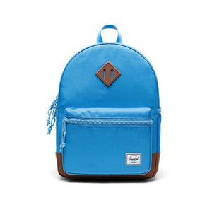 Blue backpack with a brown patch on a white background
