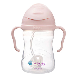 B.box sippy cup with pink lid and handles on a white background