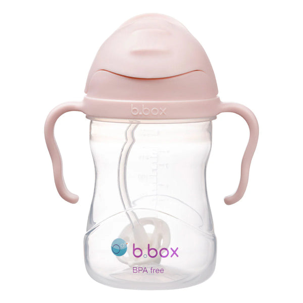 B.box sippy cup with pink lid and handles on a white background