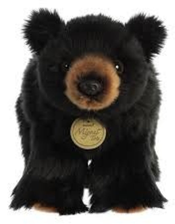 Plush bear toy with a tag on a white background