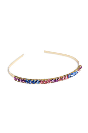A multicolored chunky gem headband with a metallic band and studded with pink, purple, and blue gems.