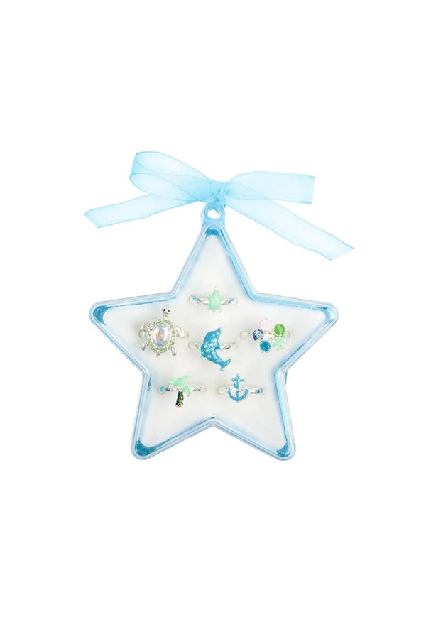 A set of six deluxe water-themed rings, including a baby green turtle, a larger turtle with gems, a glitter blue dolphin, gem flower, glitter palm tree, and a glitter anchor, presented in a blue star-shaped keepsake box with a blue organza ribbon.