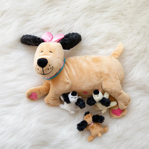 A plush toy depicting a beige mother dog with detachable black and white puppies attached by magnets.