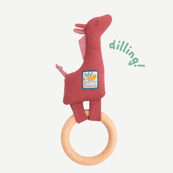 Red dinosaur-shaped teething ring with a wooden ring on a white background, featuring the brand 'dilling'.