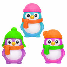 Three colorful penguin figurines wearing hats and scarves on a white background