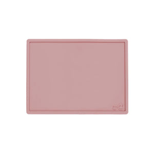 Pink silicone mat with a smiley face design on a white background