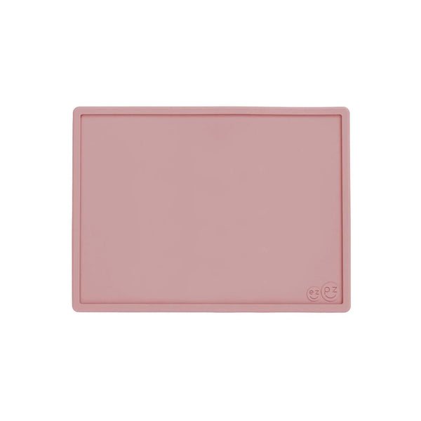 Pink silicone mat with a smiley face design on a white background
