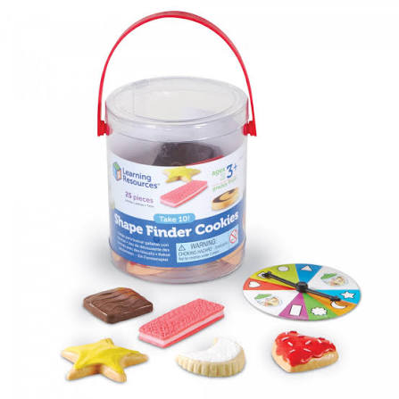 Learning Resources Shape Finder Cookie toy set in a clear plastic storage bucket with a red handle, shown with several colorful cookie pieces and a spinner wheel on a white background.
