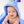 A baby hooded towel with a character design, predominantly blue, being worn by a smiling infant.
