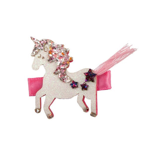 Unicorn-shaped hair clip with pink ribbon and decorative elements on a white background