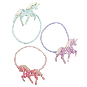 Set of four colorful unicorn-shaped hair ties on a white background