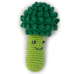 Crocheted green broccoli toy with a smiling face on a white background