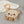 lion-shaped baby rattle with orange handle on a textured surface