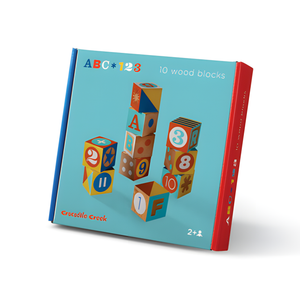 Box of colorful wooden blocks with letters and numbers on a white background