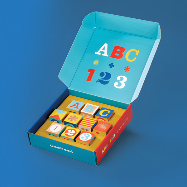 Colorful educational toy set with letters and numbers in a box on a blue background
