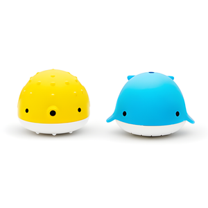 Yellow and blue toy whales on a white background