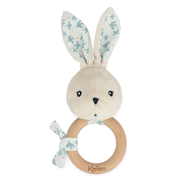 Plush rabbit toy with wooden ring and floral ears on a white background, branded 'Kaloo'.