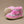 Pink and gray baby booties on a beige background