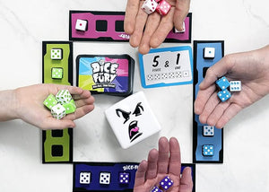 Hands holding dice and game cards with colorful packaging on a white background
