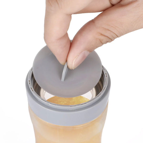 Hand placing a gray lid on a transparent container with a white background