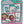 Collection of playing card sets in colorful tins with various characters on a white background