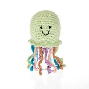 Crocheted jellyfish toy with a smiling face on a white background