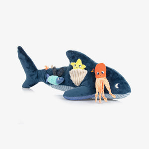 Plush shark toy with small plush characters on a white background