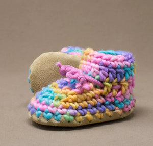 Colorful crocheted slippers on a brown background