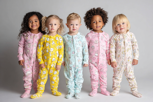Five children wearing colorful pajamas against a gray background