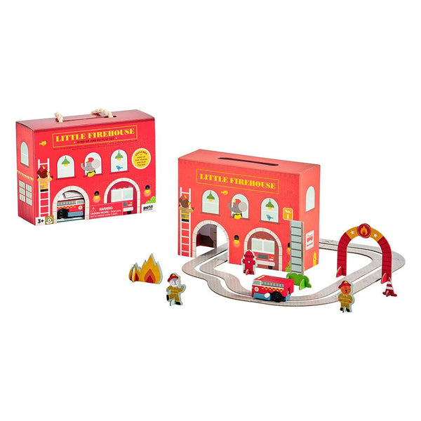 Toy firehouse set with track, figures, and fire truck on a white background