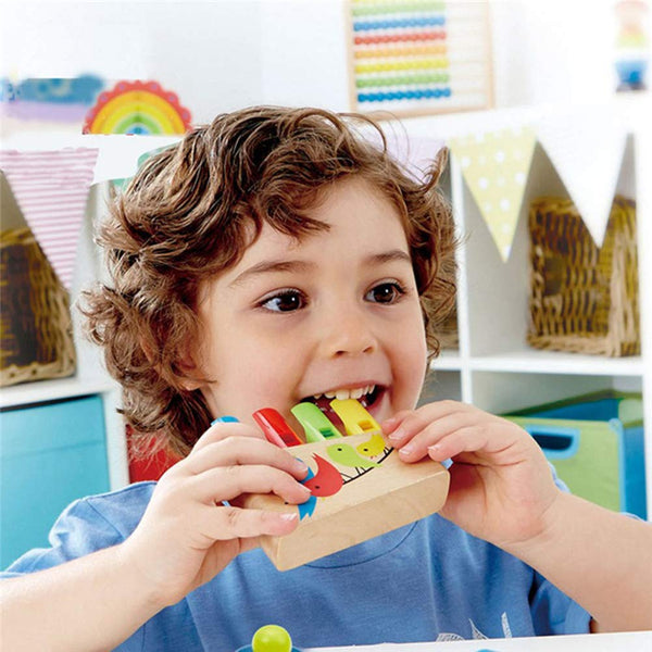 Child playing with a colorful wooden toy in a classroom setting