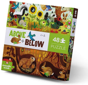 A colorful box of a 48-piece puzzle above and below the ground with various animals and plants, produced by Crocodile Creek.