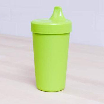 Green sippy cup on a light background